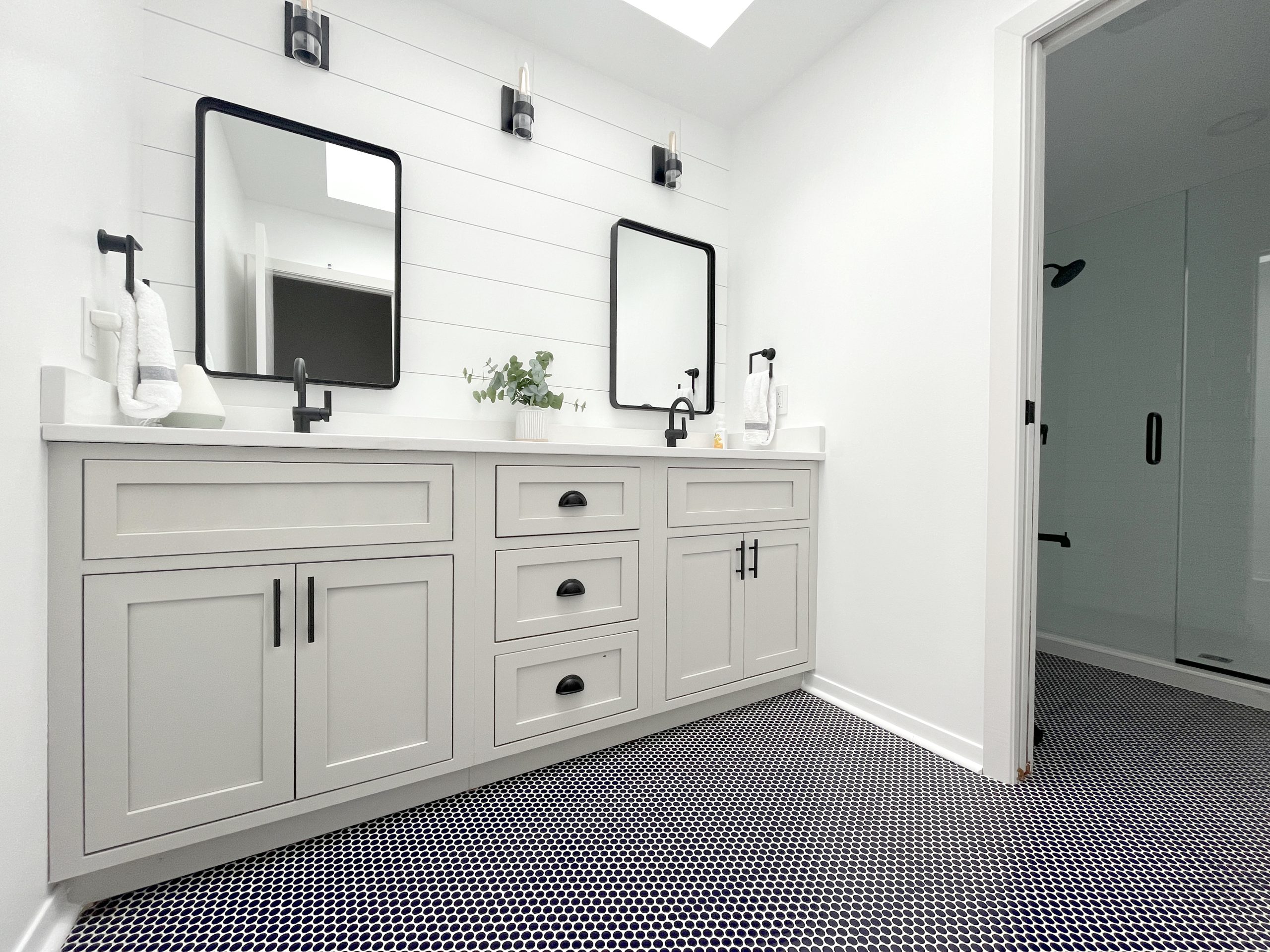 cabinet accessories for dealers such as these mirrors installed in a bright, airy bathroom